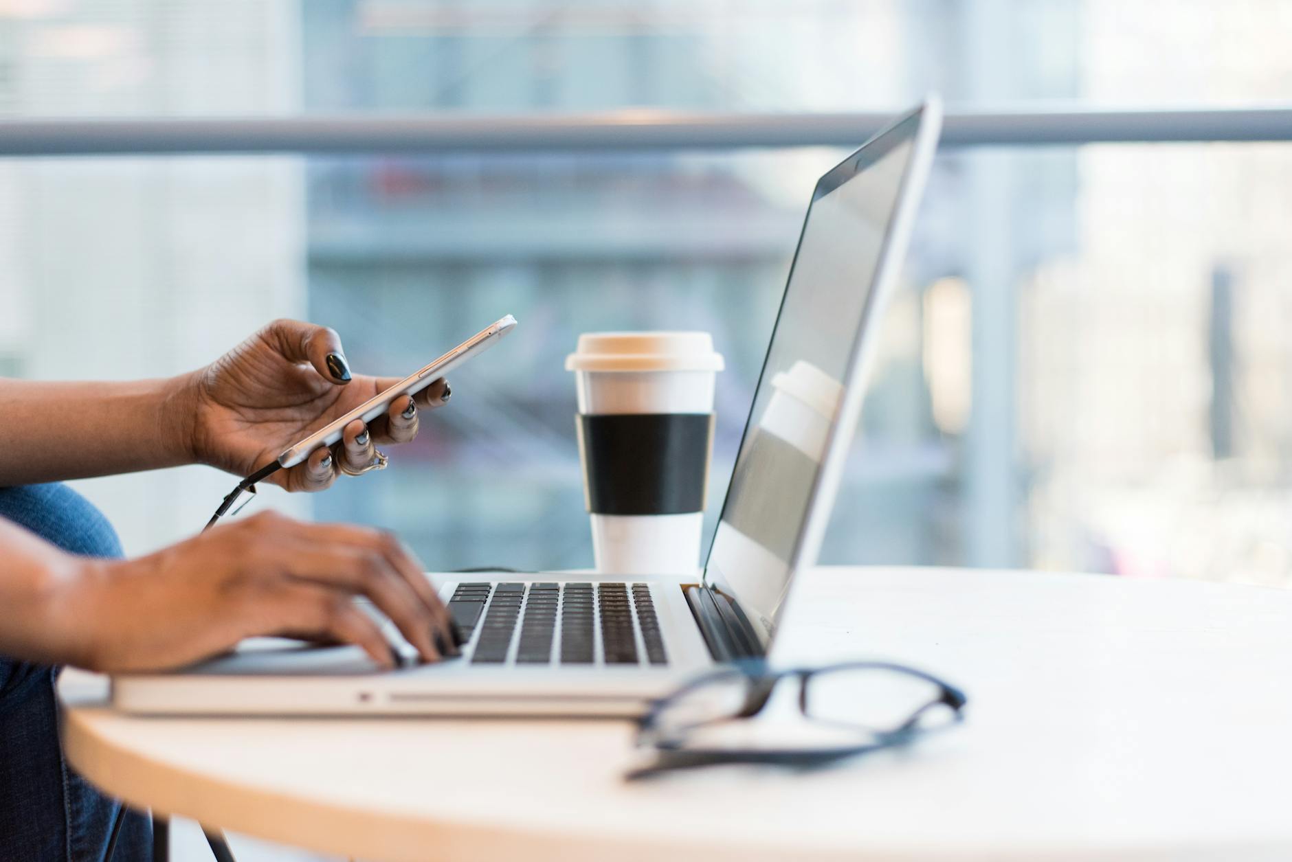 laptop on table top, showcasing coffee cup to represent corporate brandin in pretoria